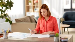 Worker at home looking at paperwork