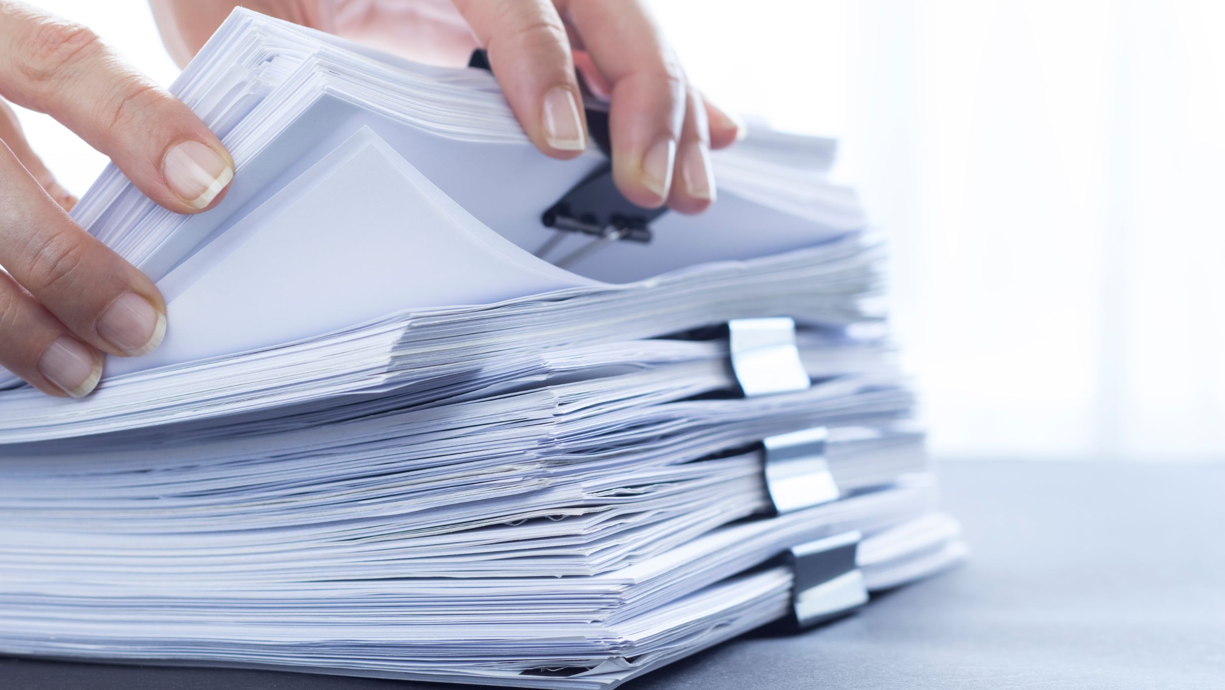 Person going through stacks of documents